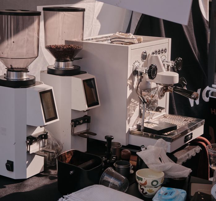 High-quality espresso machine and grinders in a cafe setting, showcasing premium coffee equipment.